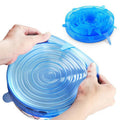 Blue silicone lid being stretched over a container by hands on a white background